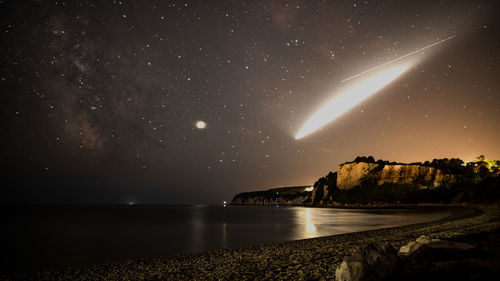 Scenic view of sea against sky at night