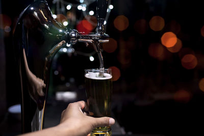 Hand and glass of beer