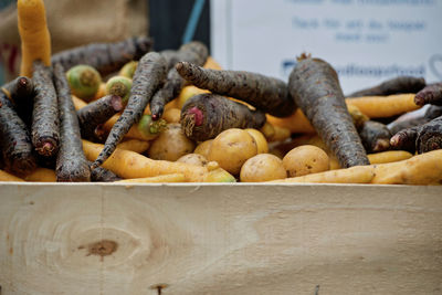 Close-up of root vegetables in a wooden box