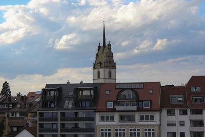 Low angle view of buildings against cloudy sky