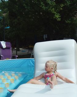 Girl sitting on inflatable raft