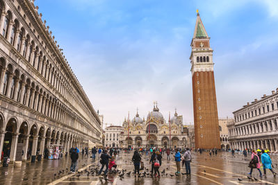 St. mark's square with a crowd and pigeons in venice, italy.