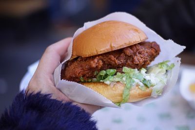 Close-up of hand holding burger