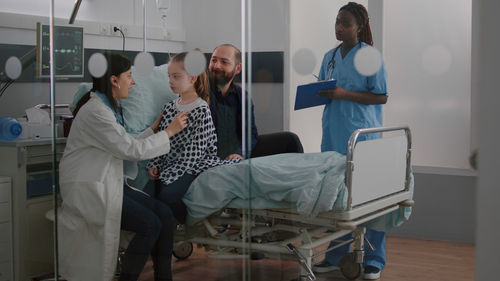 Doctor examining girl at hospital