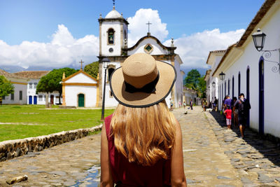 Tourism in brazil. young woman visiting the historic town of paraty, rio de janeiro, brazil.