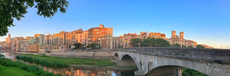 Bridge over river against clear blue sky