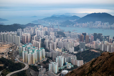 Aerial view of buildings in city against sky