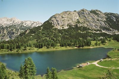 Scenic view of lake and mountains against sky