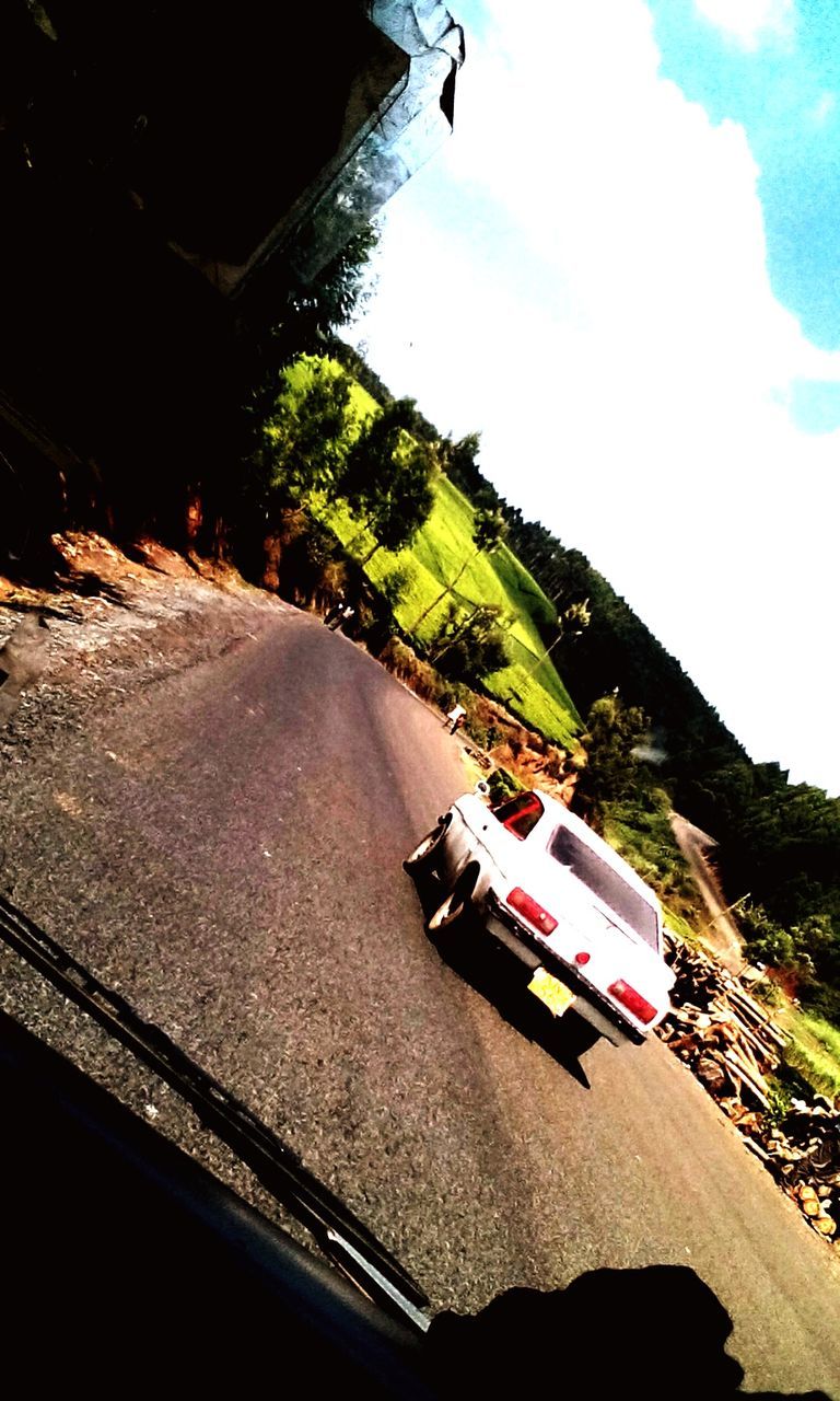 transportation, mountain, mode of transport, road, tree, car, sky, land vehicle, travel, incidental people, the way forward, day, street, on the move, sunlight, outdoors, high angle view, rock formation, nature, road marking