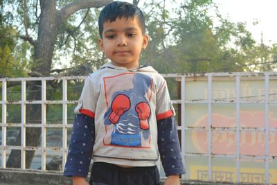 Portrait of cute boy standing outdoors