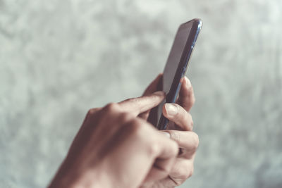 Close-up of hands using mobile phone