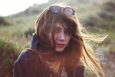 Portrait of young woman wearing sunglasses outdoors