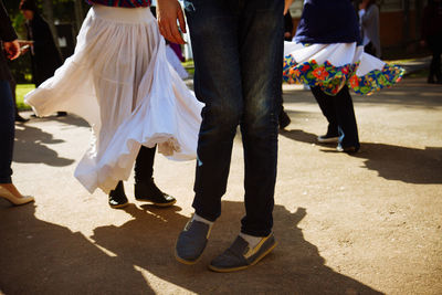 Low section of people standing on tiled floor