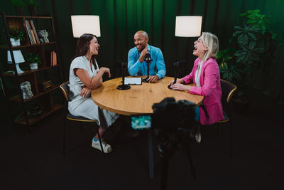 Side view of woman using mobile phone while standing at home