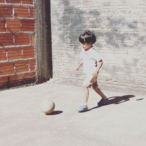 Full length of a boy playing ball