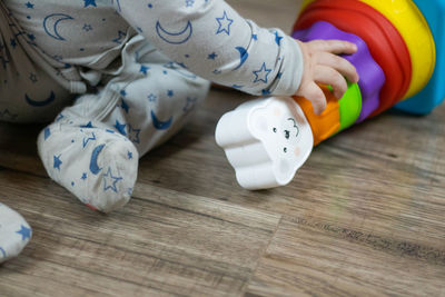 Cute baby playing with colorful rainbow toy pyramid.