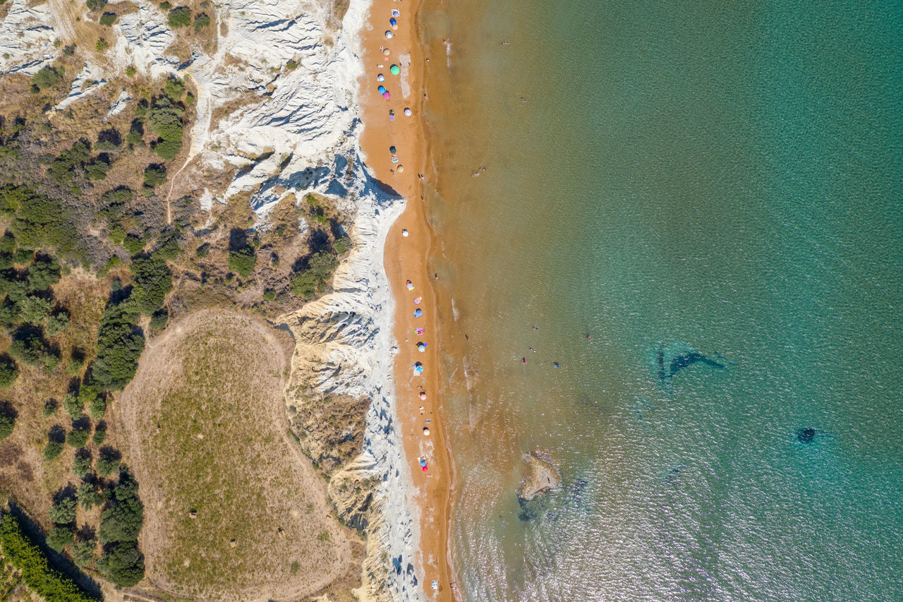 HIGH ANGLE VIEW OF BEACH SEEN THROUGH WET GLASS