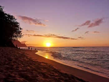 Scenic view of beach against sky during sunset