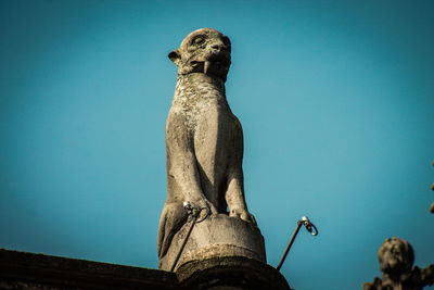 Low angle view of statue against clear blue sky