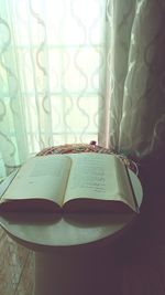 Close-up of open book on table at home