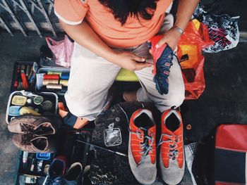 Directly above shot of man stitching shoe