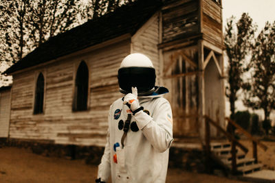 Rear view of man standing against building