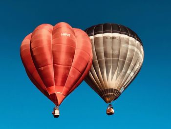 Low angle view of hot air balloon against blue sky