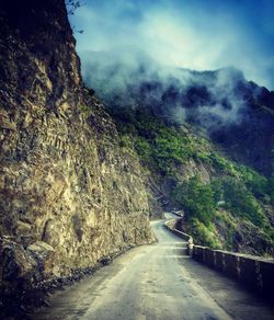 Empty road leading towards mountains