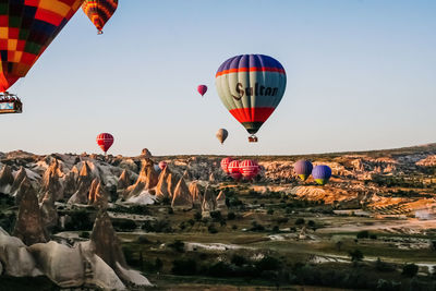 Hot air balloons over landscape