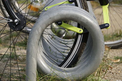 Close-up of bicycle wheel on field