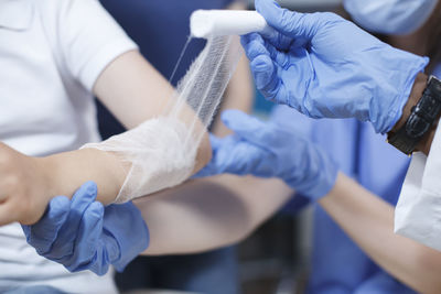 Midsection of doctor examining patient in hospital