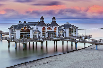 View of pier on sea against buildings