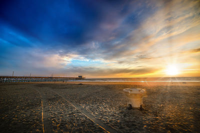 Scenic view of beach against sky during sunset