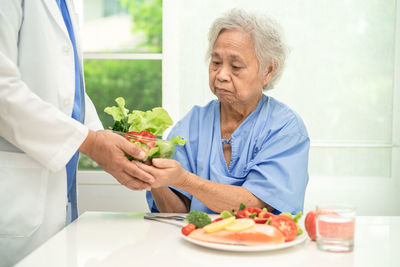 Portrait of senior man preparing food at home