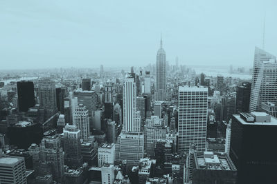 Aerial view of modern buildings in city against sky