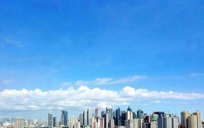 City skyline against blue sky