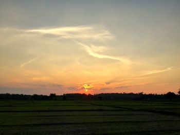 Scenic view of field against sky during sunset