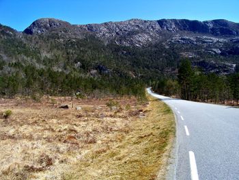 Country road leading towards mountains