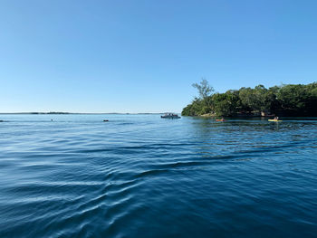 Scenic view of sea against clear blue sky