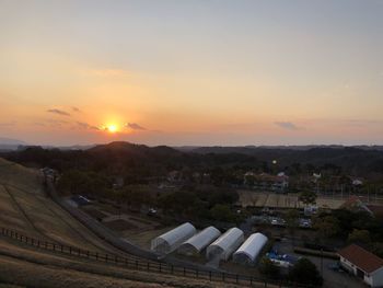 High angle view of buildings against sky during sunset