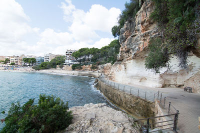 Scenic view of lake by buildings against sky