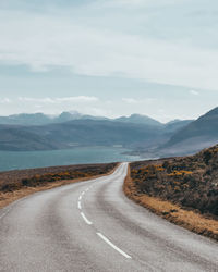 Empty road amidst field