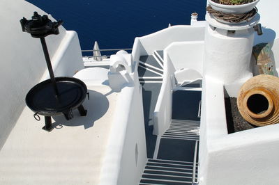 High angle view of umbrellas on table by sea against buildings