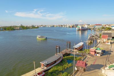 High angle view of harbor by river against sky