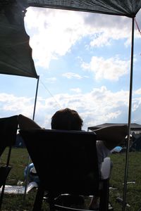 Rear view of people sitting on road