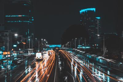 High angle view of light trails on road against sky at night