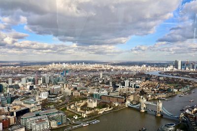 High angle view of buildings against cloudy sky