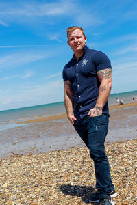 Man standing on beach against sky