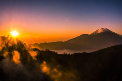 Scenic view of silhouette mountains against sky during sunset