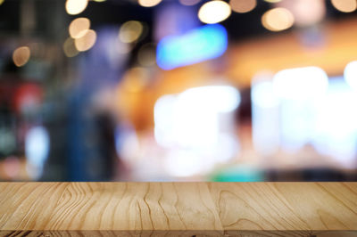 Defocused image of illuminated lights on table at home